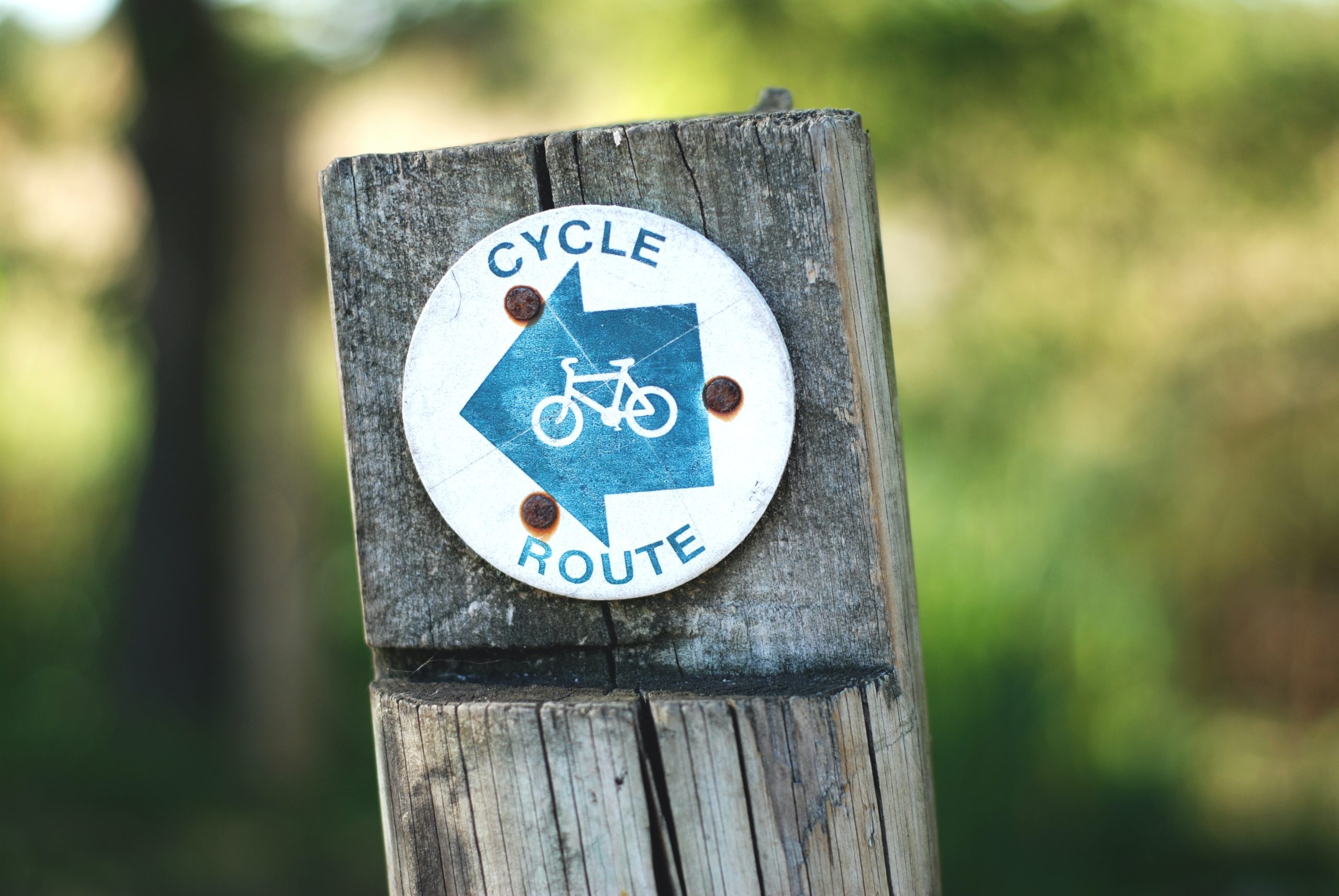 A sign making a cycle route in the countryside.